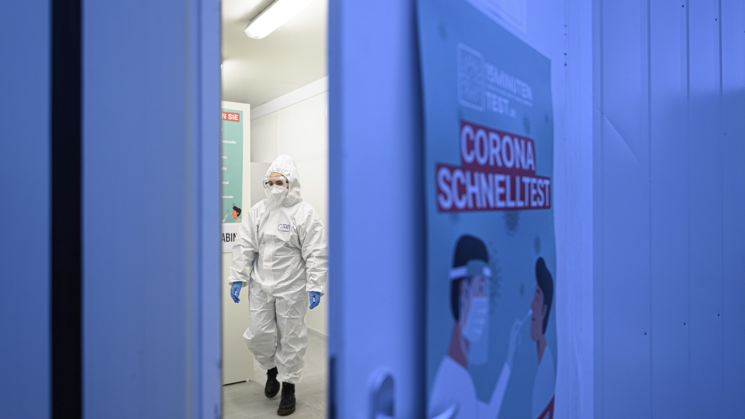 An employee of the company CoviMedical UG works in the Corona Test Center behind the Hygiene Museum in Dresden, Germany, Tuesday, Feb. 2, 2021. (Robert Michael/dpa via AP)