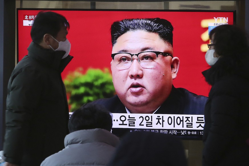 People walk by a TV screen showing North Korean leader Kim Jong Un during a ruling party congress, at the Seoul Railway Station in Seoul, South Korea, Wednesday, Jan. 6, 2021. Kim opened his country&# ...