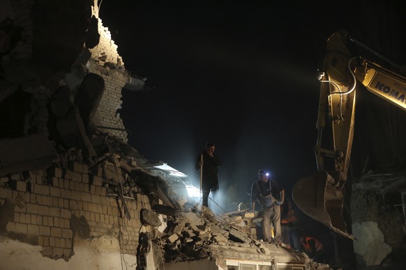 Rescuers search at collapsed building after a magnitude 6.4 earthquake in Thumane, western Albania, Tuesday, Nov. 26, 2019. Rescue crews with excavators searched for survivors trapped in toppled apart ...