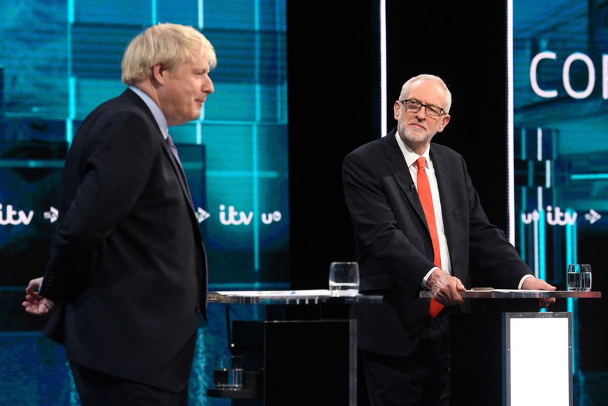 epa08009954 A handout photo made available by ITV shows British Prime Minister and Conservative Party leader Boris Johnson (L) and Labour Party leader Jeremy Corbyn (R) during live debate &#039;Johnso ...