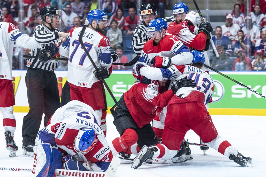 epa07588975 Players of Switzerland (red) and Czech Republic fight during the IIHF World Championship group B ice hockey match between the Czech Republic and Switzerland at the Ondrej Nepela Arena in B ...