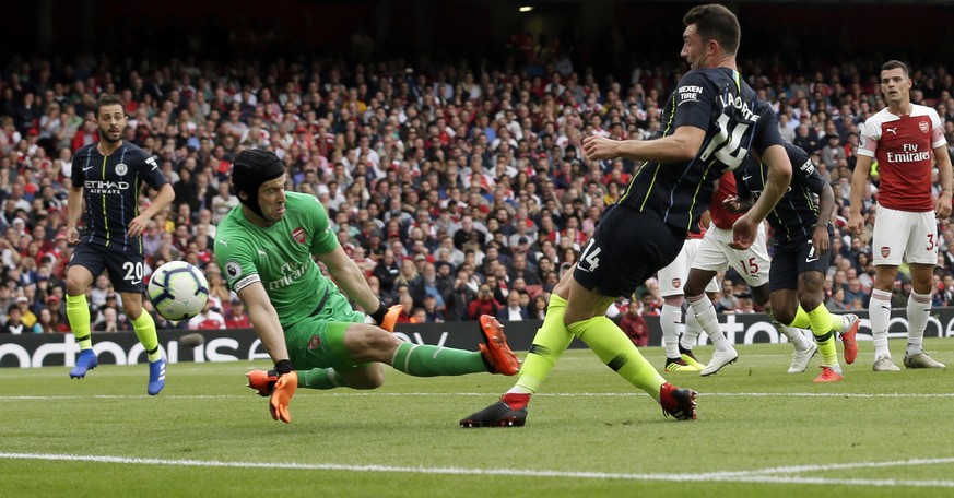 Arsenal goalkeeper Petr Cech, center, stops a shot from Manchester City&#039;s Aymeric Laporte, center right, during the English Premier League soccer match between Arsenal and Manchester City at the  ...