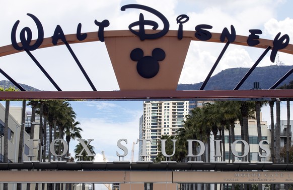 epa08583451 (FILE) - A combo picture shows the entrances of the Walt Disney Company (up) and the 21st Century Fox studios in Burbank and Los Angeles, California, 20 March 2019 (reissued 04 August 2020 ...