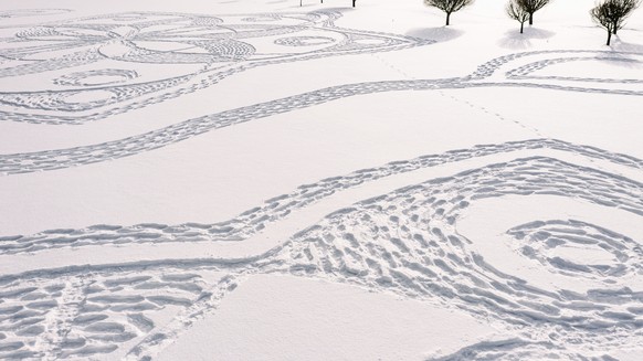 Part of a giant complex geometric pattern formed from thousands of footsteps in the snow in Espoo, Finland, Monday Feb. 8, 2021. The art work design measuring about 160 meters in diameter was made by  ...