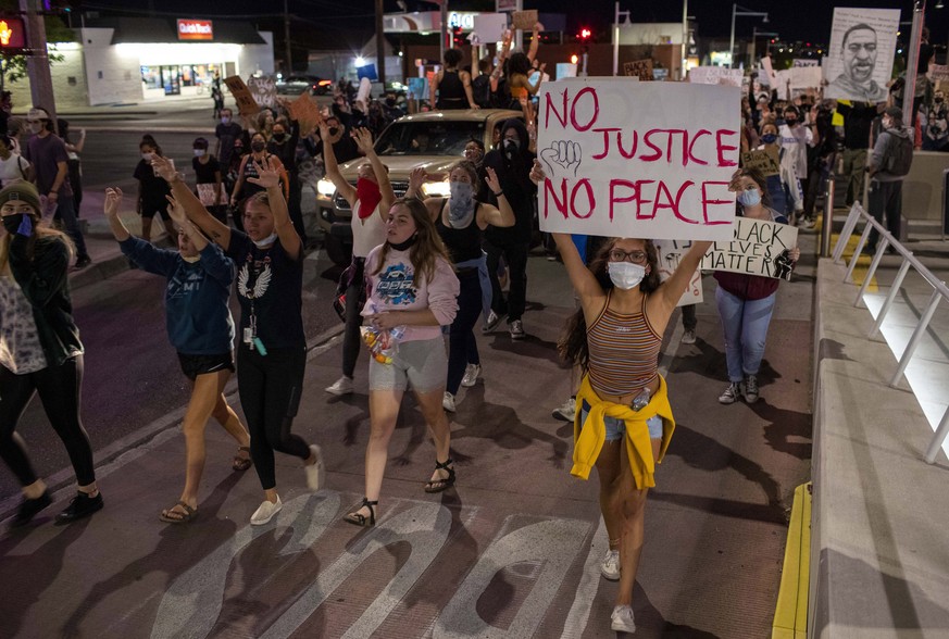 Demonstrators protest the death of George Floyd in Albuquerque, N.M., Sunday, May 31, 2020. Floyd was a black man who was killed in police custody in Minneapolis on May 25. (AP Photo/Andres Leighton)