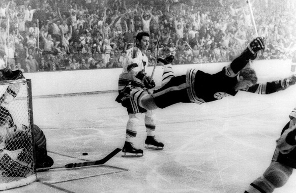 FILE - In this May 10, 1970, file photo, Boston Bruins&#039; Bobby Orr goes into orbit after scoring the goal against the St. Louis Blues that won the Stanley Cup for the Bruins in Boston. Barry Meise ...