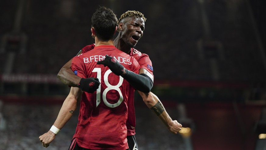 Manchester United&#039;s Bruno Fernandes, front, celebrates with Manchester United&#039;s Paul Pogba after scoring his side&#039;s fourth goal during the Europa League semi final, first leg soccer mat ...