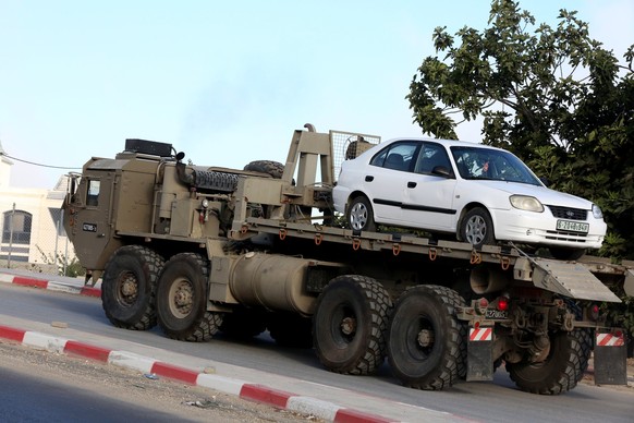 epa07765404 An Israeli army vehicle removes a Palestinian car from the West Bank village of Beit Kahil, 10 August 2019. According to reports, four suspects, three Palestinian men and a woman from the  ...