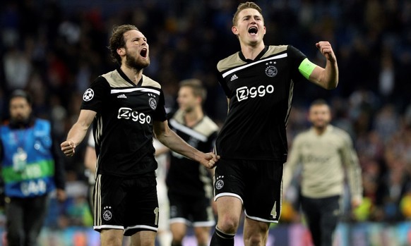epa07416144 Ajax players Daley Blind (L) and Matthijs de Ligt (R) celebrate their victory against Real Madrid at the end of a UEFA Champions League round of 16 second leg match played at the Santiago  ...