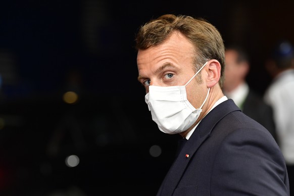French President Emmanuel Macron leaves the building after an EU summit in Brussels, Saturday, July 18, 2020. Leaders from 27 European Union nations met face-to-face for a second day of an EU summit t ...