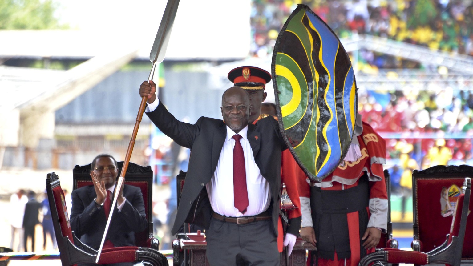 FILE - In this Nov. 5, 2015, file photo, Tanzania&#039;s President John Magufuli holds up a ceremonial spear and shield to signify the beginning of his presidency, shortly after swearing an oath durin ...