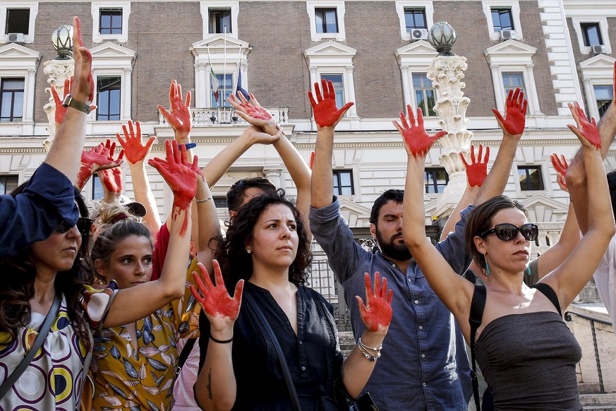 epa06896906 Protesters of Italys Radical Party with their hands painted red during a protest against the Italian Interior Minister Matteo Salvini in front of the Interior ministry in Rome, Italy 18 Ju ...