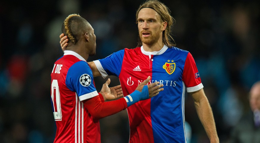 epa06587829 Michael Lang (R) of Basel reacts at the end of the match with teammate Serey Die during the UEFA Champions League round of 16 second leg soccer match between Manchester City and Basel FC i ...