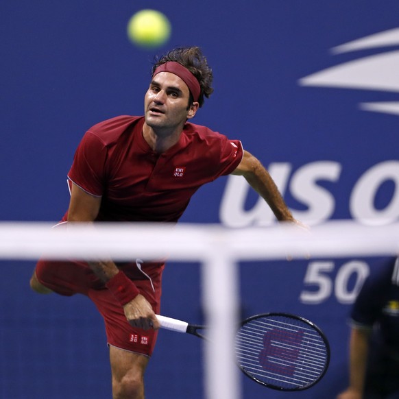 Roger Federer, of Switzerland, serves to John Millman, of Australia, during the fourth round of the U.S. Open tennis tournament, Monday, Sept. 3, 2018, in New York. (AP Photo/Adam Hunger)