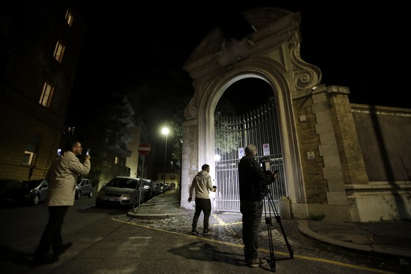Reporters film the entrance of the Vatican embassy to Italy, Tuesday, Oct. 30, 2018. The Vatican said Tuesday that human bones were found during renovation work near the embassy, reviving speculation  ...