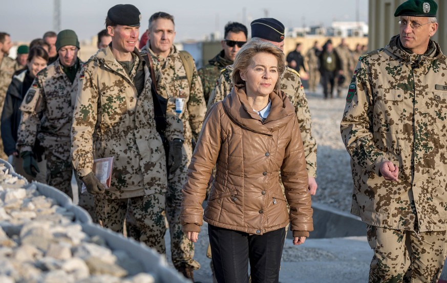 epa06398087 Germany&#039;s acting Defence Minister Ursula von der Leyen (C) has a walk with German &#039;Bundeswehr&#039; army officers at Camp Marmal in Mazar-e-Sharif, Afghanistan, 19 December 2017. ...