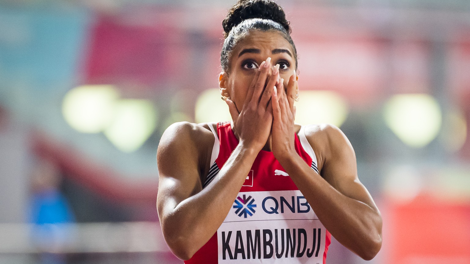 Bronze medal Mujinga Kambundji from Switzerland celebrates during the women&#039;s 200 meters final at the IAAF World Athletics Championships, at the Khalifa International Stadium, in Doha, Qatar, Wed ...