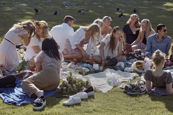 FILE - In this Friday June 19, 2020 file photo people picnic during the annual Midsummer celebrations in Stockholm, Sweden. Sweden&#039;s relatively low-key approach to coronavirus lockdowns captured  ...