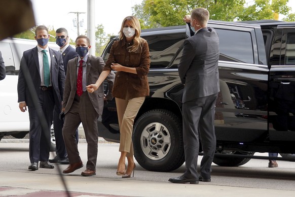 First lady Melania Trump adjust her sleeve as she stops for a visit at the Manchester Fire Department Central Station, Thursday, Sept. 17, 2020, in Manchester, N.H. (AP Photo/Mary Schwalm)
