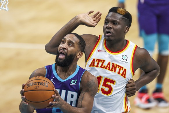 Charlotte Hornets guard Brad Wanamaker, left, drives to the basket in front of Atlanta Hawks center Clint Capela, right, during the third quarter of an NBA basketball game in Charlotte, N.C., Sunday,  ...