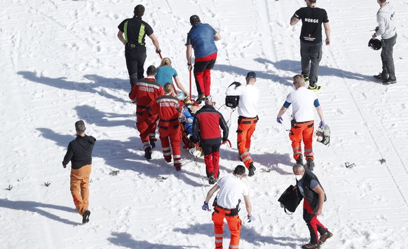 Healthcare workers attend to Norway&#039;s Daniel Andre Tande after he crashed during the ski flying individual World Cup event in Planica, Slovenia, Thursday, March 25, 2021. (AP Photo)
