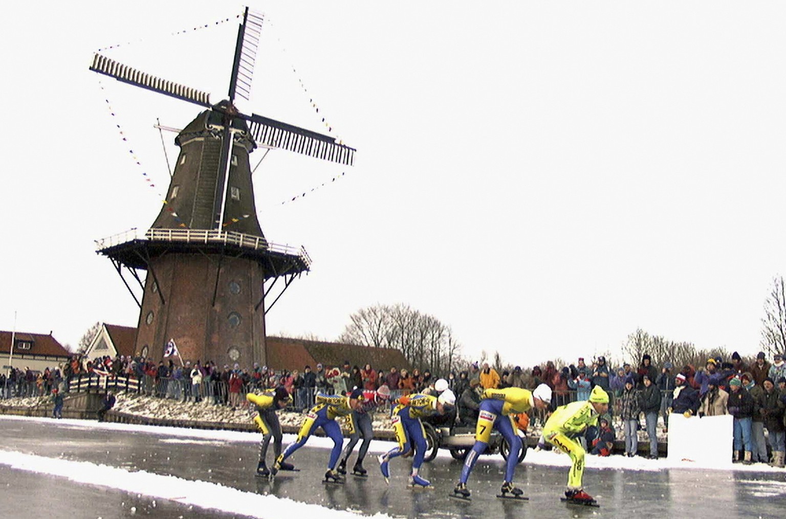 FILE - In this Jan. 4, 1997, file photo, skaters pass a windmill as some 16,000 people participate in the historic 200km skating spectacle the &#039;Elfstedentocht&#039; (eleven-cities-course) in Bird ...