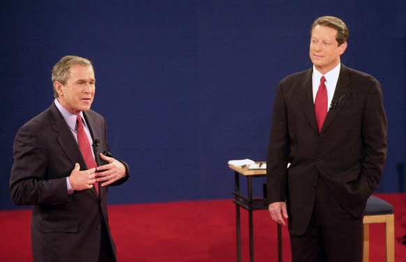 FILE - In this Oct. 17, 2000 file photo, Republican presidential candidate, Texas Gov. George W. Bush, left, speaks as Democratic presidential candidate Vice President Al Gore watches during their thi ...