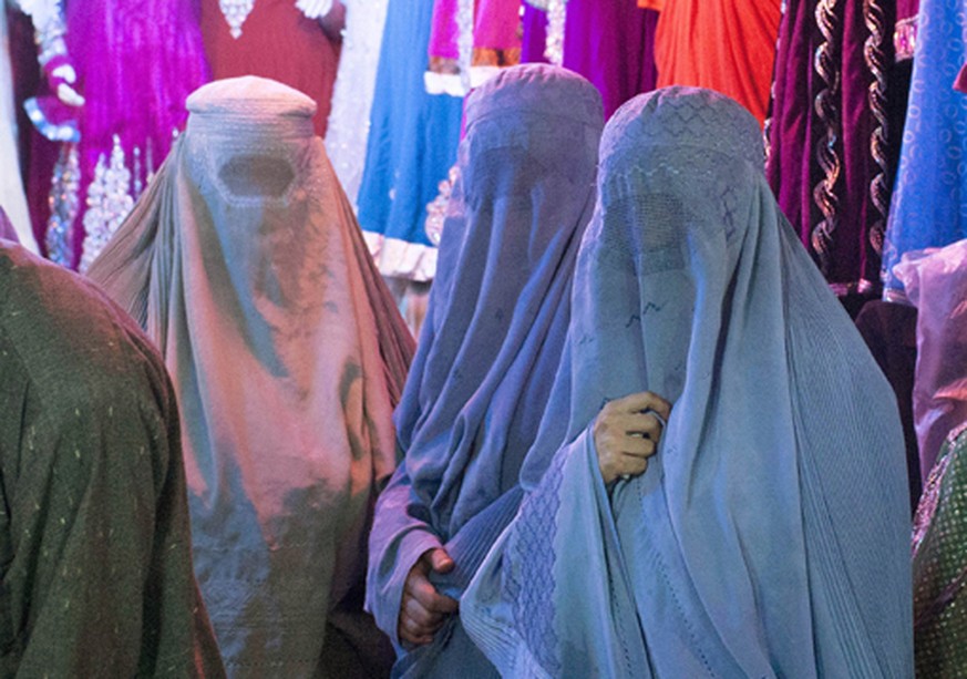 In this Oct. 23, 2012 photo, Afghan women shop in a crowded bazaar in the heart of Lashkar Gah, southern Helmand’s provincial capital in Afghanistan. After 11 years of war residents of southern Helman ...