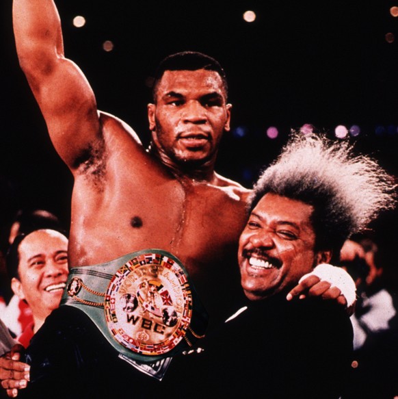 FILE--Boxer Mike Tyson is held high by promoter Don King after knocking out Tervor Berbick to become the youngest heavyweight champion in this Nov. 22, 1986 file photo in Las Vegas. William Eaddy, 33, ...