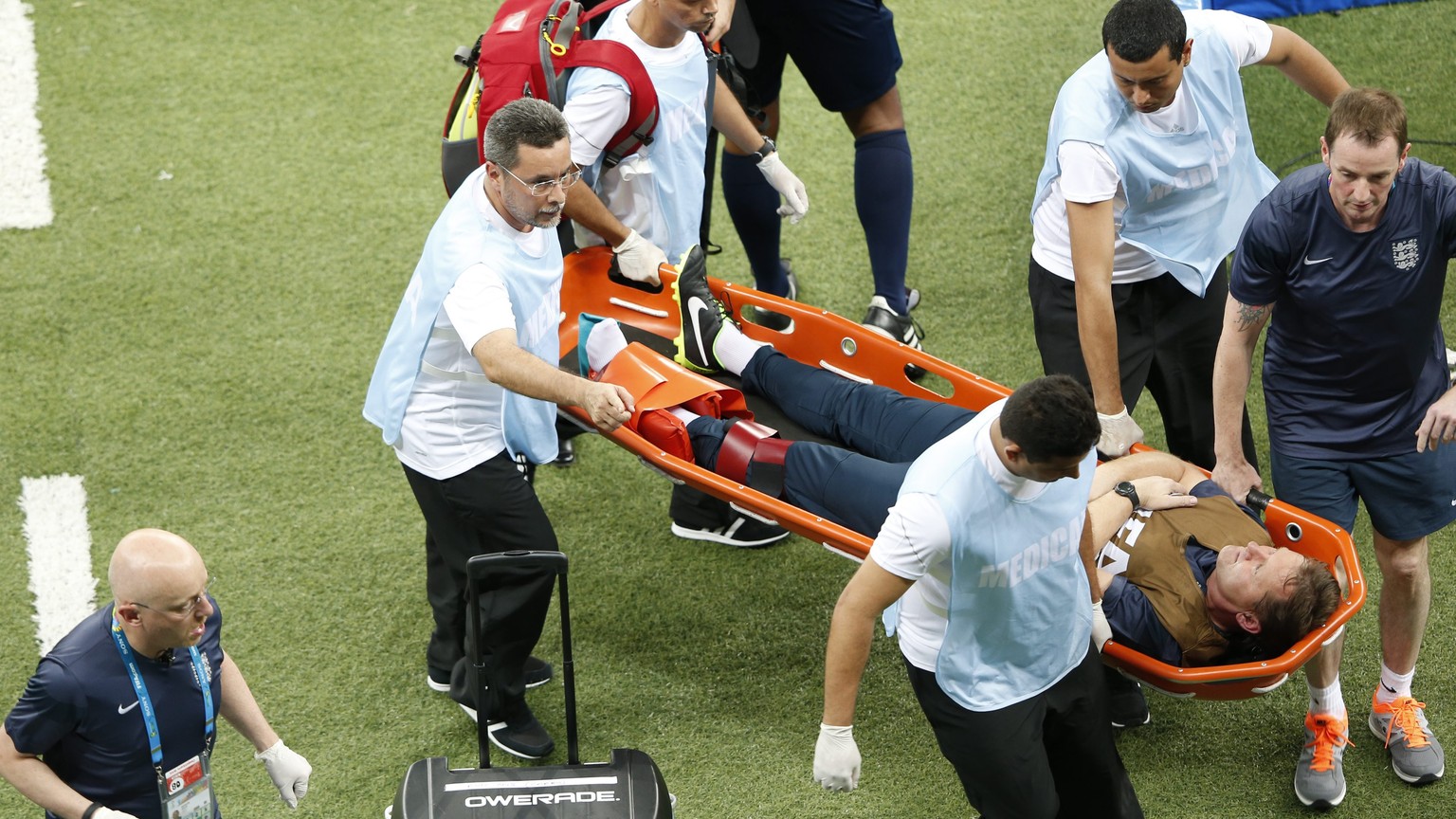 epa04257758 Physiotherapist Gary Lewin of England is stretcherd off the pitch after picking up an injury during the FIFA World Cup 2014 group D preliminary round match between England and Italy at the ...