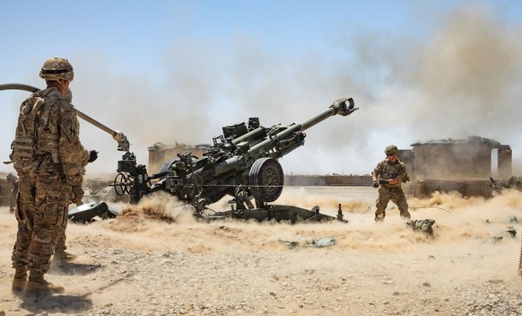 epa07832227 A handout photo made available by the US Army shows Soldiers from the 1-118th Field Artillery Regiment of the 48th Infantry Brigade Combat Team firing an M777 Howitzer during a fire missio ...