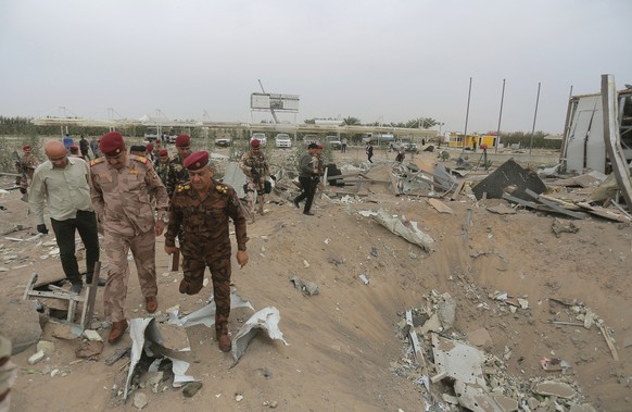 Iraqi army soldiers inspect the destruction at an airport complex under construction in Karbala, Iraq, Friday, March 13, 2020. Iraq&#039;s military said five security force members and a civilian were ...