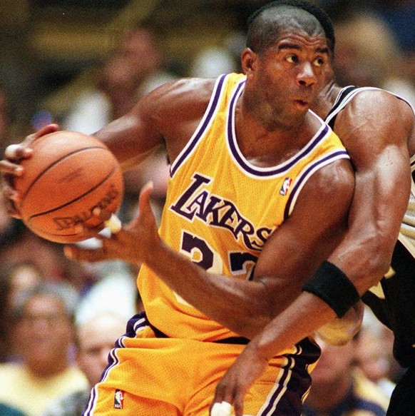 FILE--Los Angeles Lakers&#039; Earvin &quot;Magic&quot; Johnson spins around a pick thrown by San Antonio Spurs&#039; Charles Smith during the first quarter Sunday, April 7, 1996, in Inglewood, Calif. ...