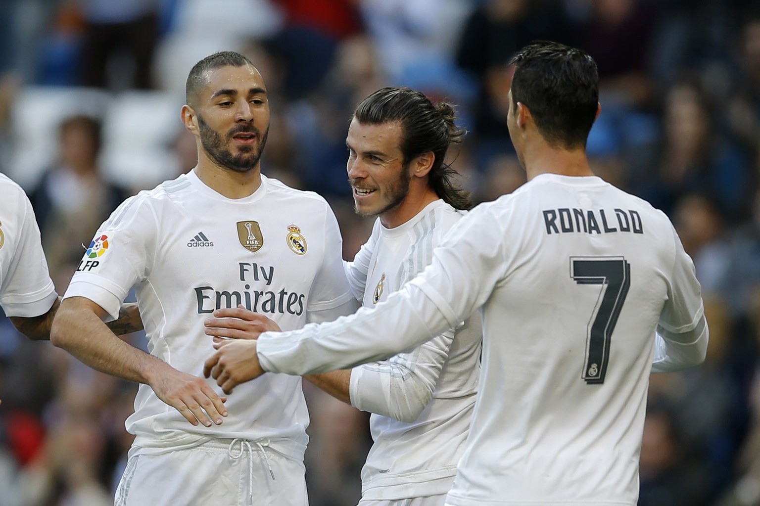 Real Madrid&#039;s Karim Benzema, left, celebrates with teammates Cristiano Ronaldo, right, and Gareth Bale after scoring their side&#039;s third goal against Getafe during the Spanish La Liga soccer  ...