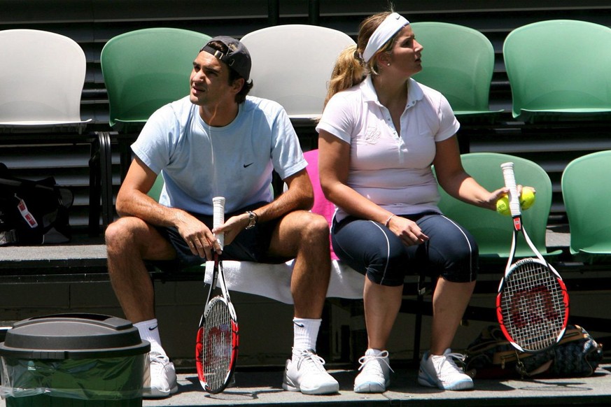 Roger Federer (left) and his girlfriend Miroslava &#039;Mirka&#039; Vavrinec, take a break during Federer&#039;s first practice session of the year at the Rod Laver Arena in Melbourne, Wednesday, 03 J ...