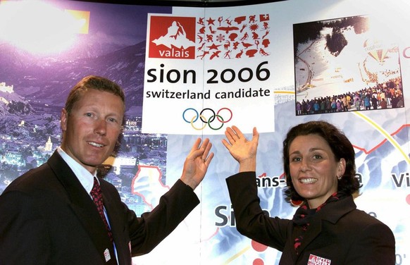 Former Swiss alpine skiing champions Maria Walliser and Pirmin Zurbriggen pose with the logo of Sion 2006 candidature city, at the International Olympic Comittee (IOC) session, in Seoul, Korea, Thursd ...