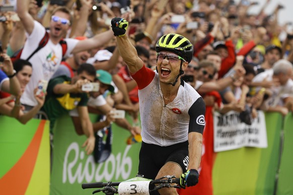 FILE - In this Saturday, Aug. 20, 2016 file photo, Nino Schurter of Switzerland celebrates after finishing first in the men&#039;s cross-country cycling mountain bike race at the 2016 Summer Olympics  ...