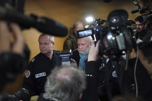 Former French priest Bernard Preynat, center, arrives at the Lyon court house, central France, Monday Jan.13, 2020. Bernard Preynat, is accused of sexually abusing some 75 Boy Scouts went on trial Mon ...