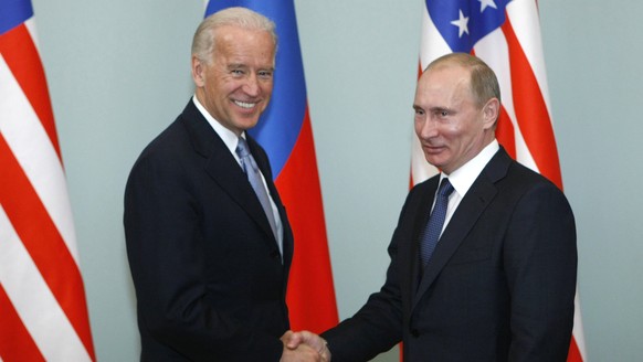 FILE - In this March 10, 2011, file photo, then-Vice President Joe Biden, left, shakes hands with Russian Prime Minister Vladimir Putin in Moscow, Russia. Hit by a barrage of new sanctions from the Bi ...