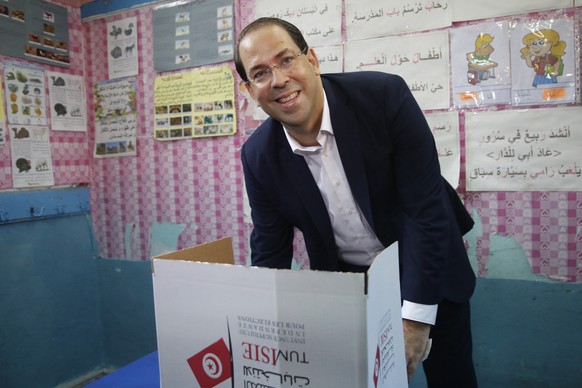 Current Tunisian Prime Minister and presidential candidate Youssef Chahed prepares to cast his ballot during the first round of the presidential election, in La Marsa, outside Tunis, Tunisia, Sunday S ...