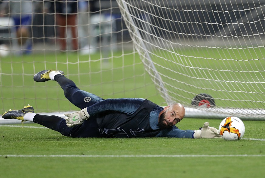Chelsea goalkeeper Willy Caballero dives for a save during a soccer training session at the Olympic stadium in Baku, Azerbaijan, Tuesday May 28, 2019. English Premier League teams Arsenal and Chelsea  ...