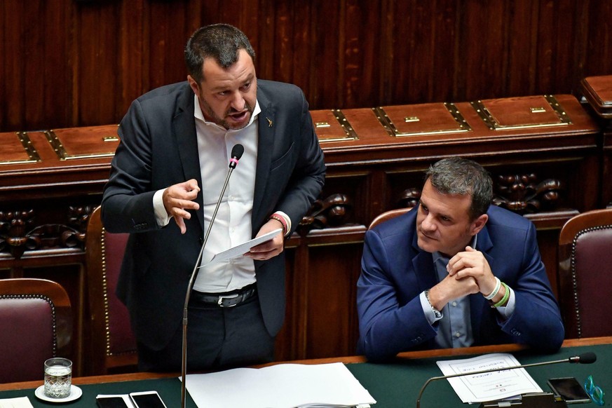 Italian Deputy Premier and Interior Minister Matteo Salvini, left, is flanked by the Minister For Agricultural Resources ,Gian Marco Centinaio, as he addresses the Lower Chamber in Rome, Wednesday, Ju ...