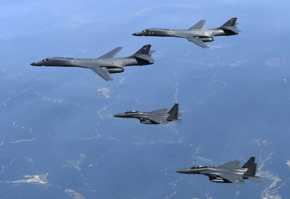 FILE - In this June 20, 2017 file photo provided by South Korean Defense Ministry, U.S. Air Force B-1B bombers, top, and second from top, and South Korean fighter jets F-15K fly over the Korean Penins ...