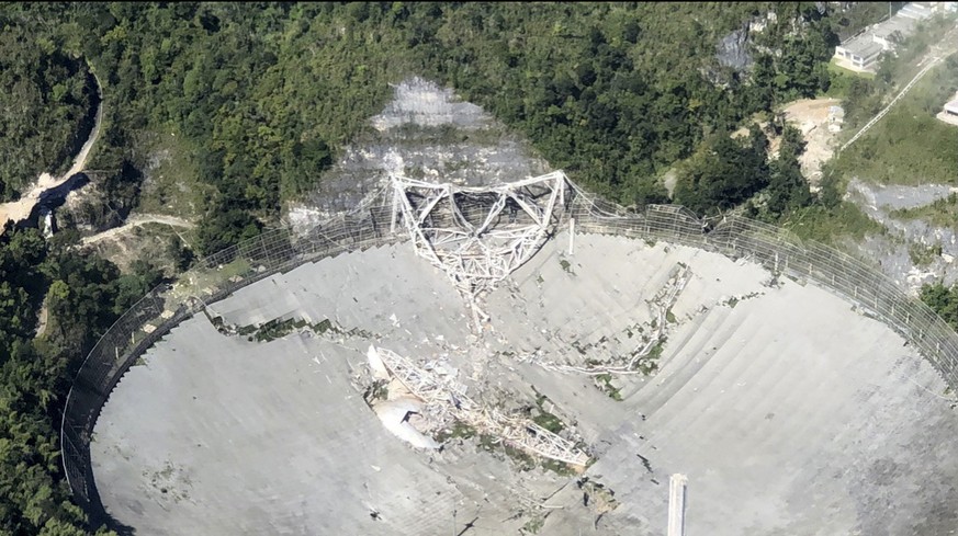 This photo provided by Aeromed shows the collapsed Radio Telescope in Arecibo, Puerto Rico, Tuesday, Dec. 1, 2020. The already damaged radio telescope that has played a key role in astronomical discov ...