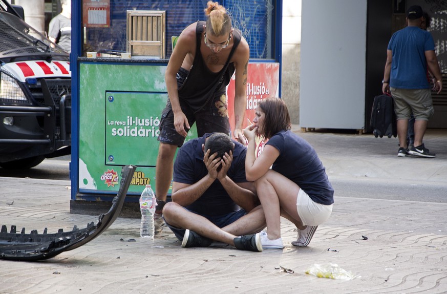 epa06148638 Injured people react after a van crashed into pedestrians in Las Ramblas, downtown Barcelona, Spain, 17 August 2017. According to initial reports a van crashed into a crowd in Barcelona&#0 ...