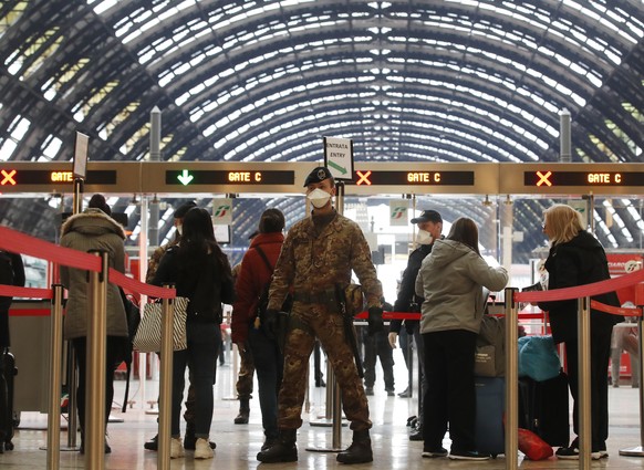 Police officers and soldiers check passengers leaving from Milan main train station, Italy, Monday, March 9, 2020. Italy took a page from China&#039;s playbook Sunday, attempting to lock down 16 milli ...
