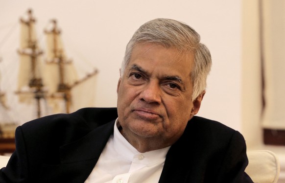 FILE -In this Friday, Nov. 2, 2018, file photo, ousted Sri Lankan Prime Minister Ranil Wickremesinghe listens during an interview with the Associated Press at his official residence in Colombo, Sri La ...