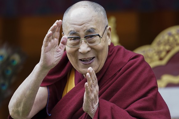 FILE - In this April 5, 2017, file photo, Tibetan spiritual leader the Dalai Lama greets devotees at the Buddha Park in Bomdila, Arunachal Pradesh, India. More than 150 Tibetan religious leaders say t ...