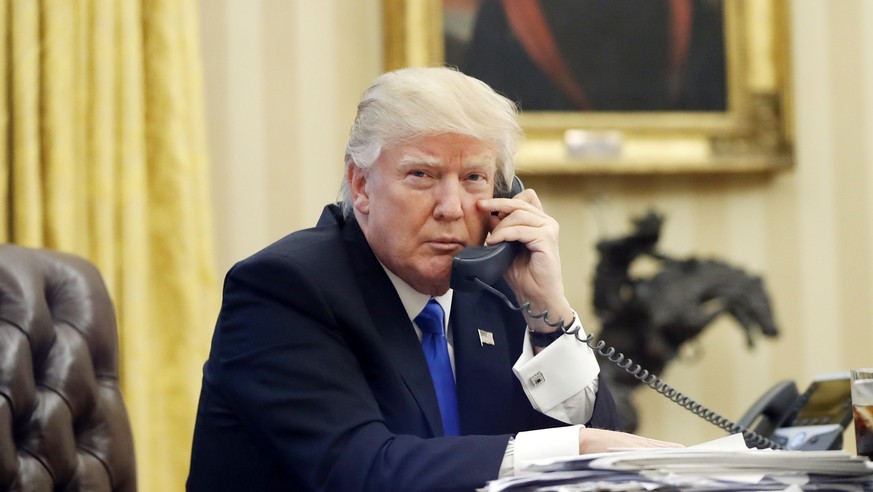 FILE - In this Jan. 28, 2017, file photo, U.S. President Donald Trump speaks on the phone with Prime Minister of Australia Malcolm Turnbull in the Oval Office of the White House in Washington. For dec ...