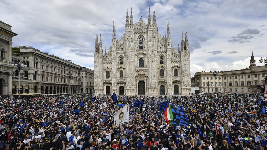 Inter Milan fans crowd Piazza Duomo square in front of the gothic cathedral after Inter Milan won its first Serie A title in more than a decade after second-placed Atalanta drew 1-1 at Sassuolo, in Mi ...